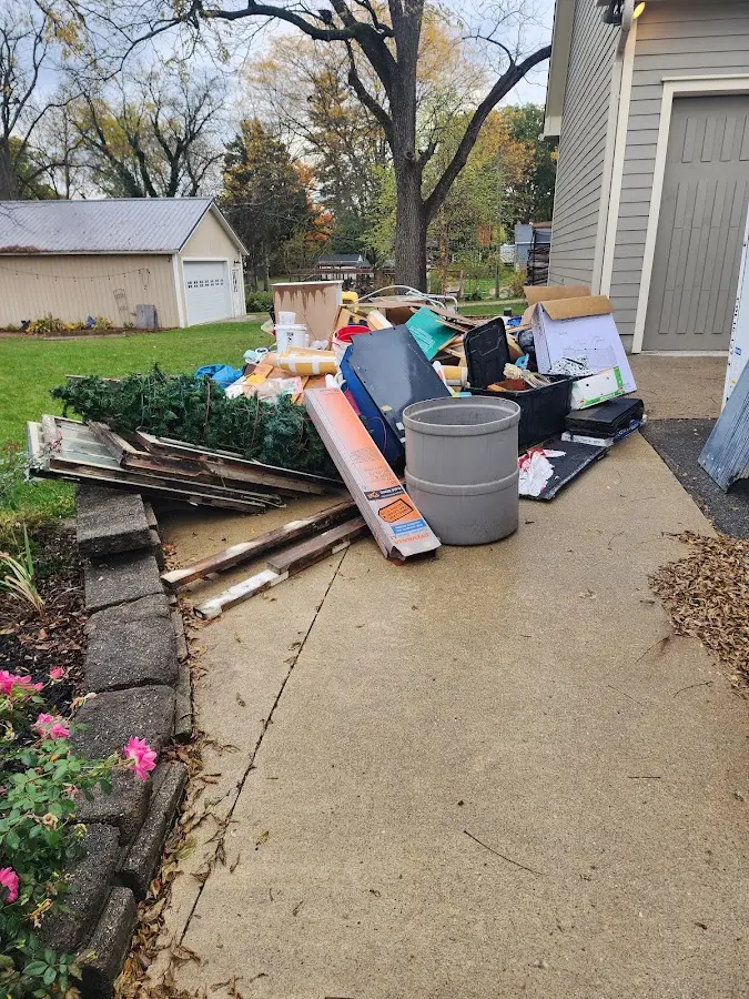 Dumpster being loaded with debris for Roofing Dumpster Rental in Bloomingdale